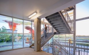An indoor staircase with colorful glass windows