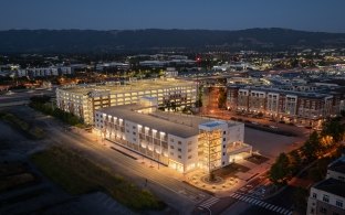 Exterior, nighttime view of the parking structure