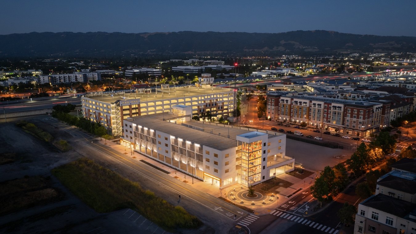 Exterior, nighttime view of the parking structure