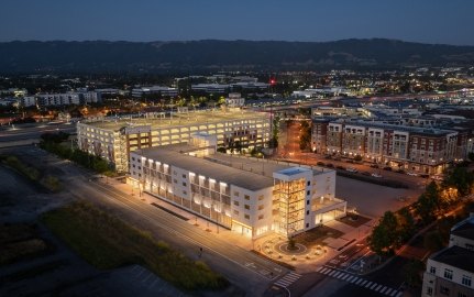 Exterior, nighttime view of the parking structure