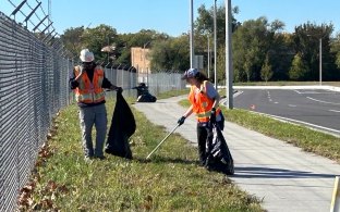 Two people picking up trash at a community volunteer event.