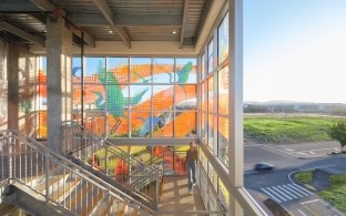 An indoor staircase with colorful glass windows