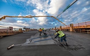 People working on finishing the concrete