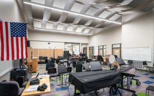 The music room at Beveridge Magnet Middle School full of chairs and instruments.
