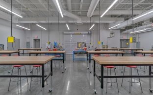 Buena Vista High School classroom interior with high tables, stools and hanging electrical outlets