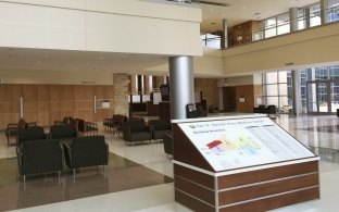 A lobby area with chairs and a large map