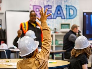 Child raising their hand.
