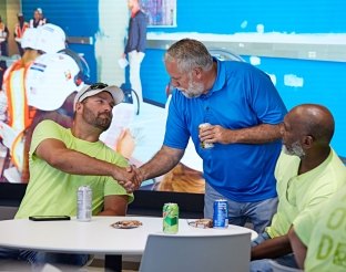 Three people shaking hands.