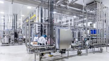 Indoor image of workers working at a station