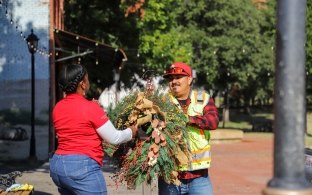 Two people handling an item at a community volunteer event.