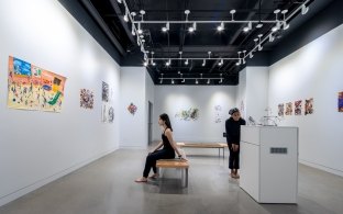 A white-walled art gallery within Kinder High School.