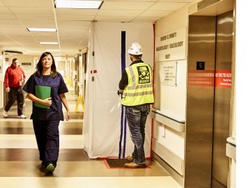 Person working inside of a hospital and a nurse.