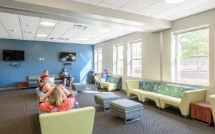 A lobby area with lounge chairs