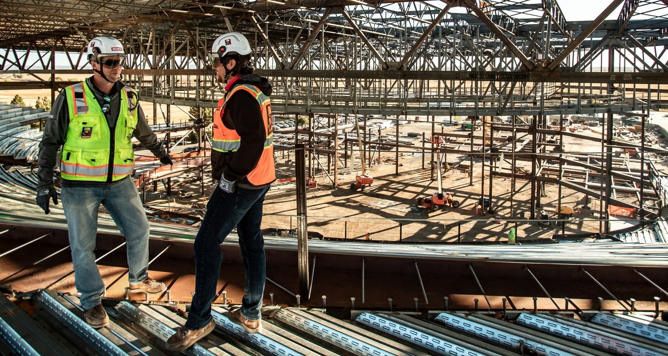Construction workers having a conversation on a jobsite.
