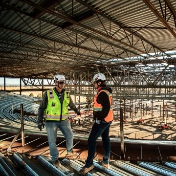 Construction workers having a conversation on a jobsite.