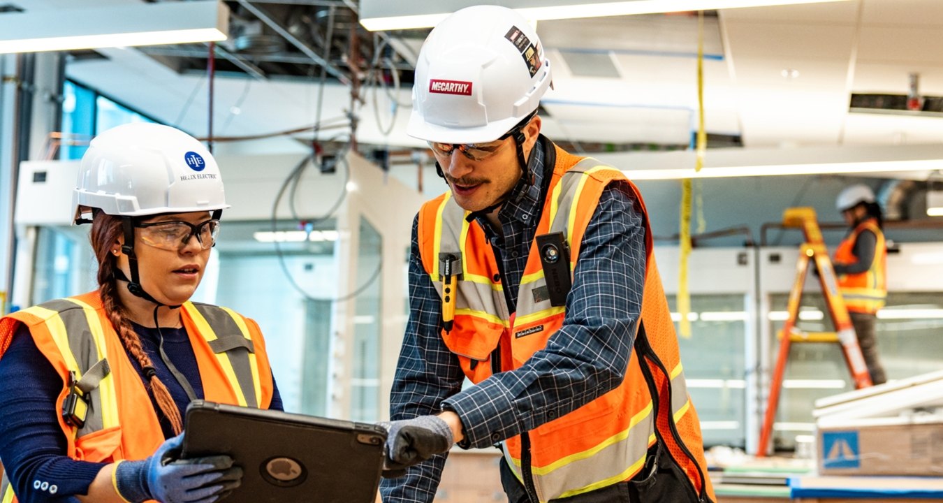 Two people working at a jobsite