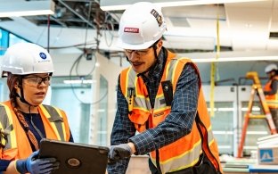 Two people working at a jobsite