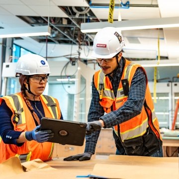 Two people working at a jobsite