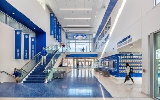 An open lobby area with a staircase on the left side of the image.