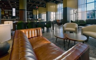 Couch, table chairs and other seating areas in the Nebraska Innovation Campus Scarlet Hotel lounge