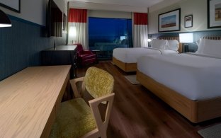Nebraska Innovation Campus Scarlet Hotel guest room with two beds and desk
