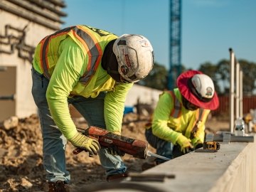 Two people working on a jobsite