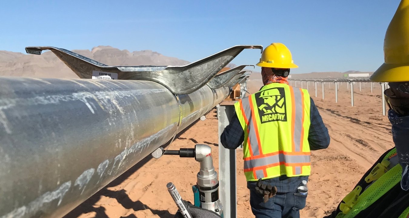 Solar workers tackle a metal installation at the Arrow Canyon Solar project to start 2022.