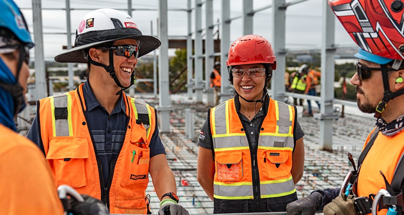 A group of people talking at a jobsite.